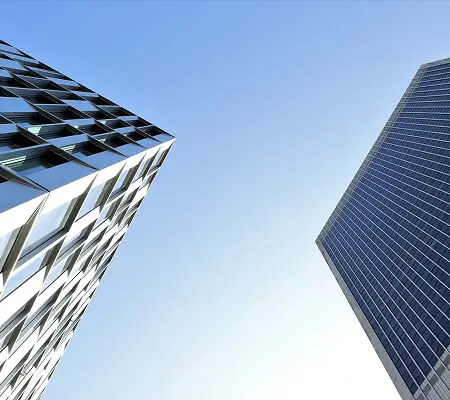 Tall buildings viewed from below representing the insurance industry